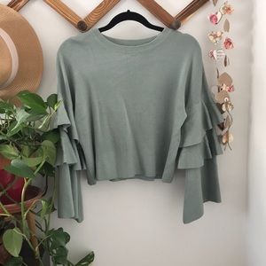 Green sweater with embellished sleeves